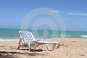 The paradores on the beach offer this type of lounge chair to tourists photo
