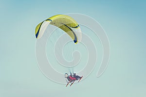 paraglide flying over clear blue winter sky