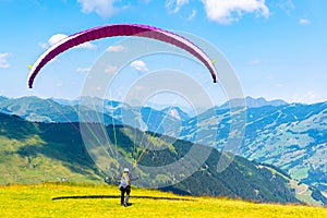 Paraglide launching. Starting procedure of paraglider on high mountain meadow. Recreational and competitive adventure