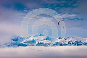 Paraglide over snow-capped peaks