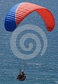 Paraglider agains sunny ocean