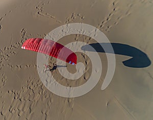 Paraglider on the background of sand dune, top view