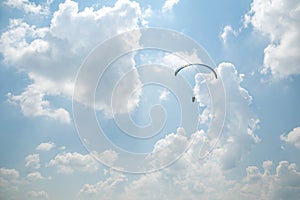 Paraglider in the blue sky, big blue clouds