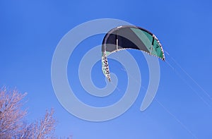 Paraglider in blue sky winter. Snow Kiting. Winter sports