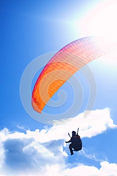 Paraglider on bright blue sky photo