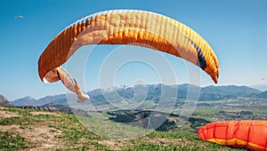 Paraglider catch a wind with his paraplane