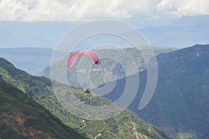 Paraglider enjoying the spectacular view of the scenery, Chicamocha Canyon
