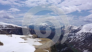 Paraglider flies over the snow-capped mountains. Mountains of the Caucasus