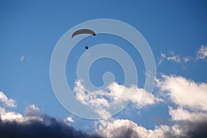 Paraglider flies in stormy skies