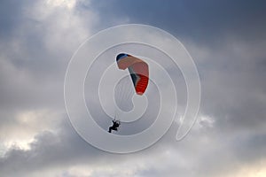 Paraglider flies in stormy skies