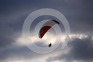 Paraglider flies in stormy skies