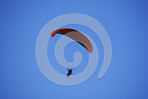 Paraglider flies in stormy skies