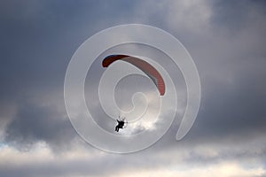 Paraglider flies in stormy skies