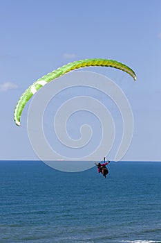 Paraglider flying above Mediterranean