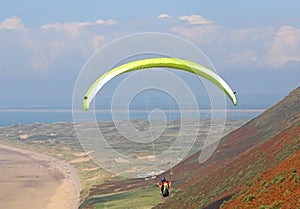 Paraglider flying above Rhossili