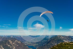 Paraglider flying in blue sky