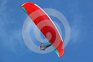 Paraglider flying in a blue skyt