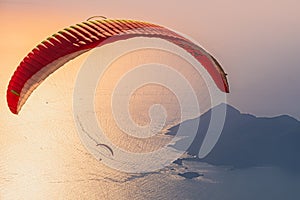 Paraglider flying on Oludeniz beach in Fethiye at sunset. Mugla, Turkey. Travel destination. Summer and holiday concept