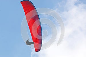 Paraglider flying wing in a blue sky