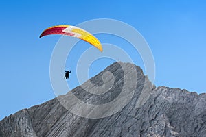 Paraglider free soaring in cloudless sky over dolomites Alpine m