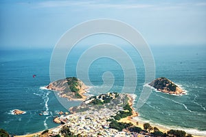 A paraglider glides over Shek O from the Dragon`s Back Trail in Shek O Country Park, Hong Kong