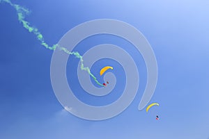 Paraglider with green smoke