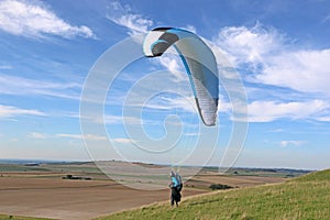 Paraglider launching at Milk Hill, Wiltshire