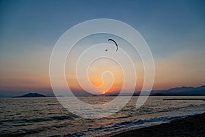 Paraglider over the beach during Sunset on the Calis Beach on the Aegean Sea