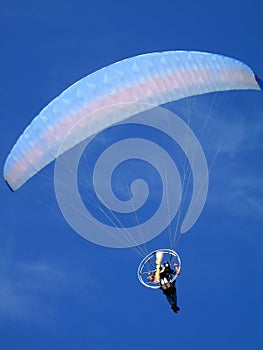 Paraglider over blue sky