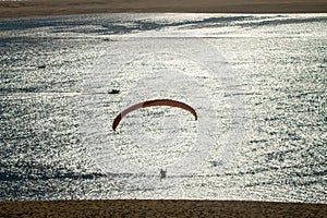 Paraglider over dunes and water at the Dune of Pilat