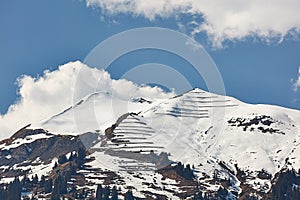 Paraglider over snowy peaks of Vilan massif