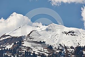 Paraglider over snowy peaks of Vilan massif