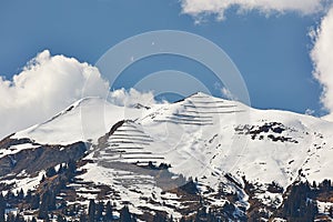 Paraglider over snowy peaks of Vilan massif