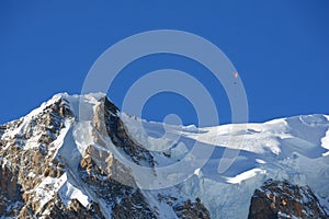Paraglider over the summit of Mont Blanc massif, Italy photo