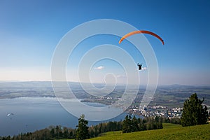 Paraglider over the Zug city, Zugersee and Swiss Alps