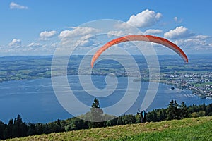 Paraglider over the Zug city, Zugersee and Swiss Alps, Switzerland