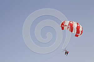 Paraglider with a saddle for people. Parasales - water parachutes. Bright colours