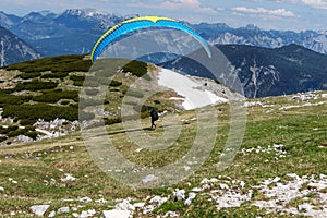 A paraglider at the start of the Krippenstein mountain in the Dachstein Mountains. Salzkammergut. Austria