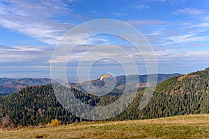 Paraglider taking off from mountain