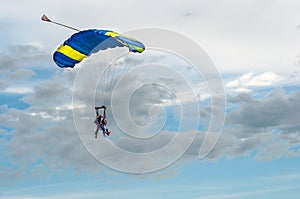 Paraglider tandem fly against the blue sky.