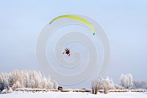 paraglider with two people in flight