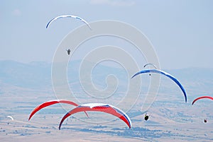 Paragliders on a background of blue sky.