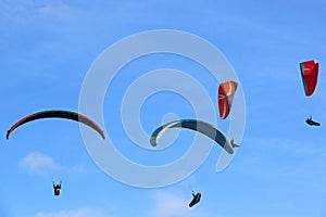 Paragliders flying in a blue sky