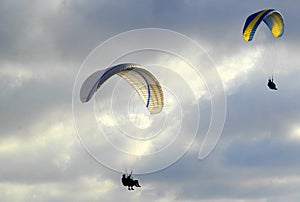 Paragliders flying into the clouds