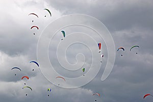 Paragliders flying in a cloudy sky