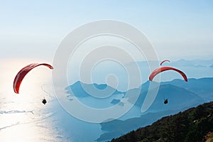 Paragliders flying on Oludeniz beach in Fethiye, Mugla. Travel destination. Summer and holiday concept
