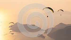 Paragliders flying on Oludeniz beach at sunset in Fethiye, Mugla. Summer and holiday concept