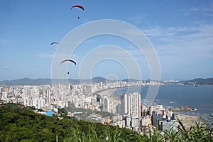 Paragliders flying over the city of Santos and Sao Vicente