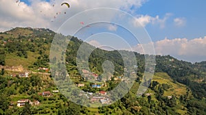 Paragliders flying over Sarangkot in Pokhara, Nepal