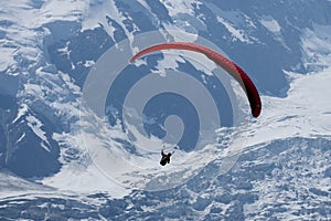 Paragliders looking for thermals amongst the snow caps of the Monte Blanc Massif, Chamonix,